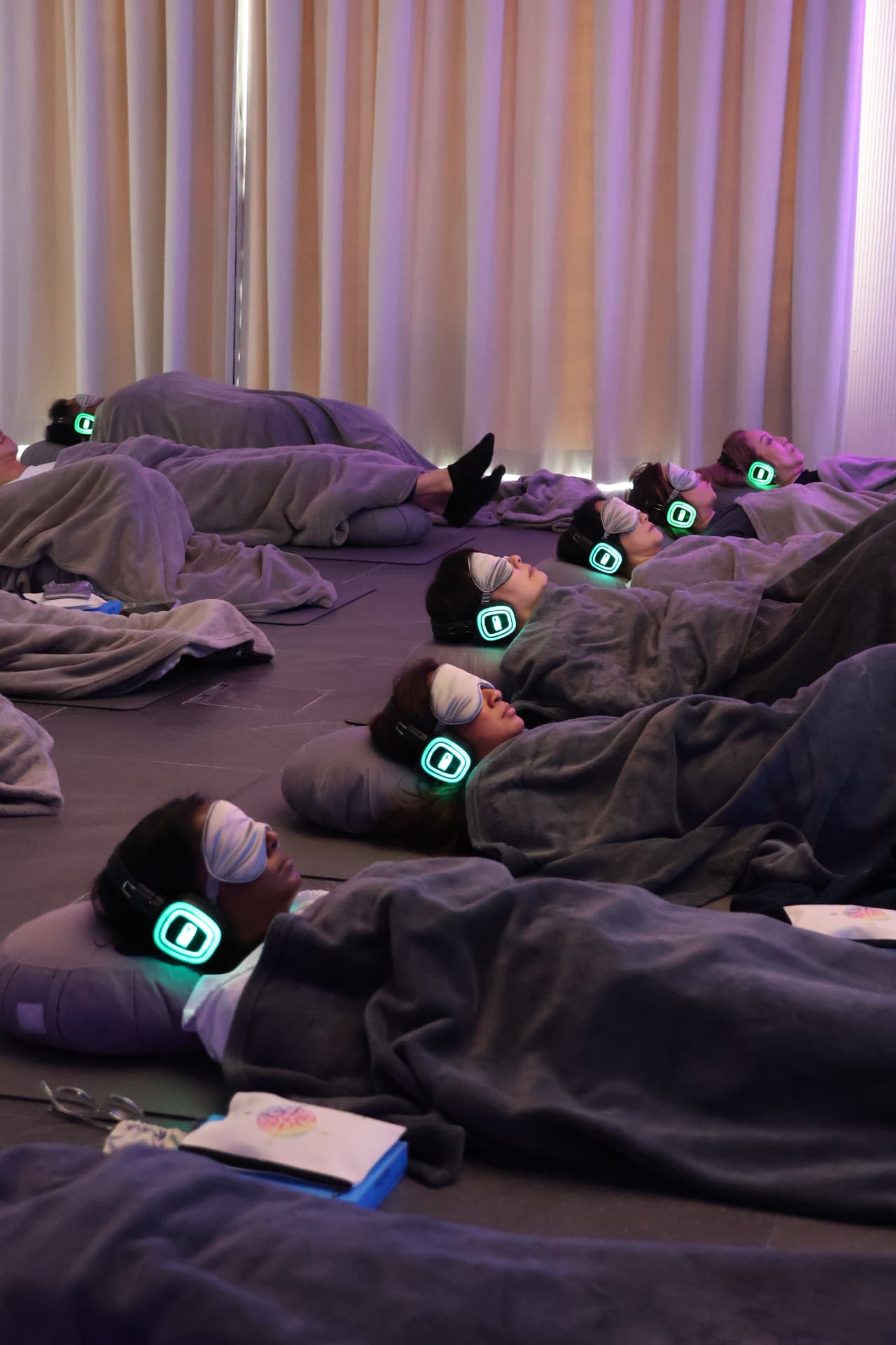 Guests resting with blankets and glowing headphones