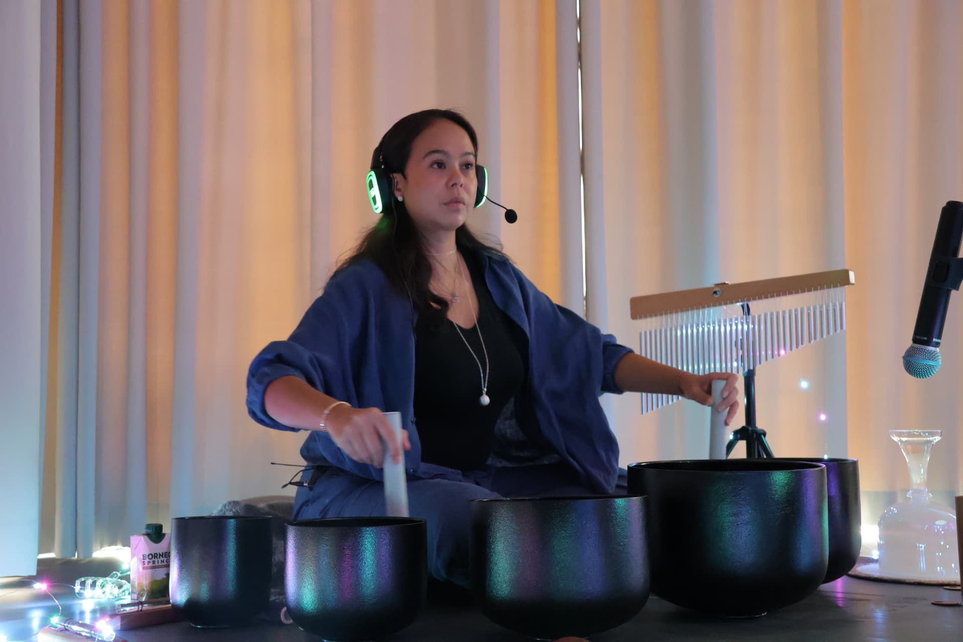 Tunku Tiara playing crystal singing bowls and bar chimes