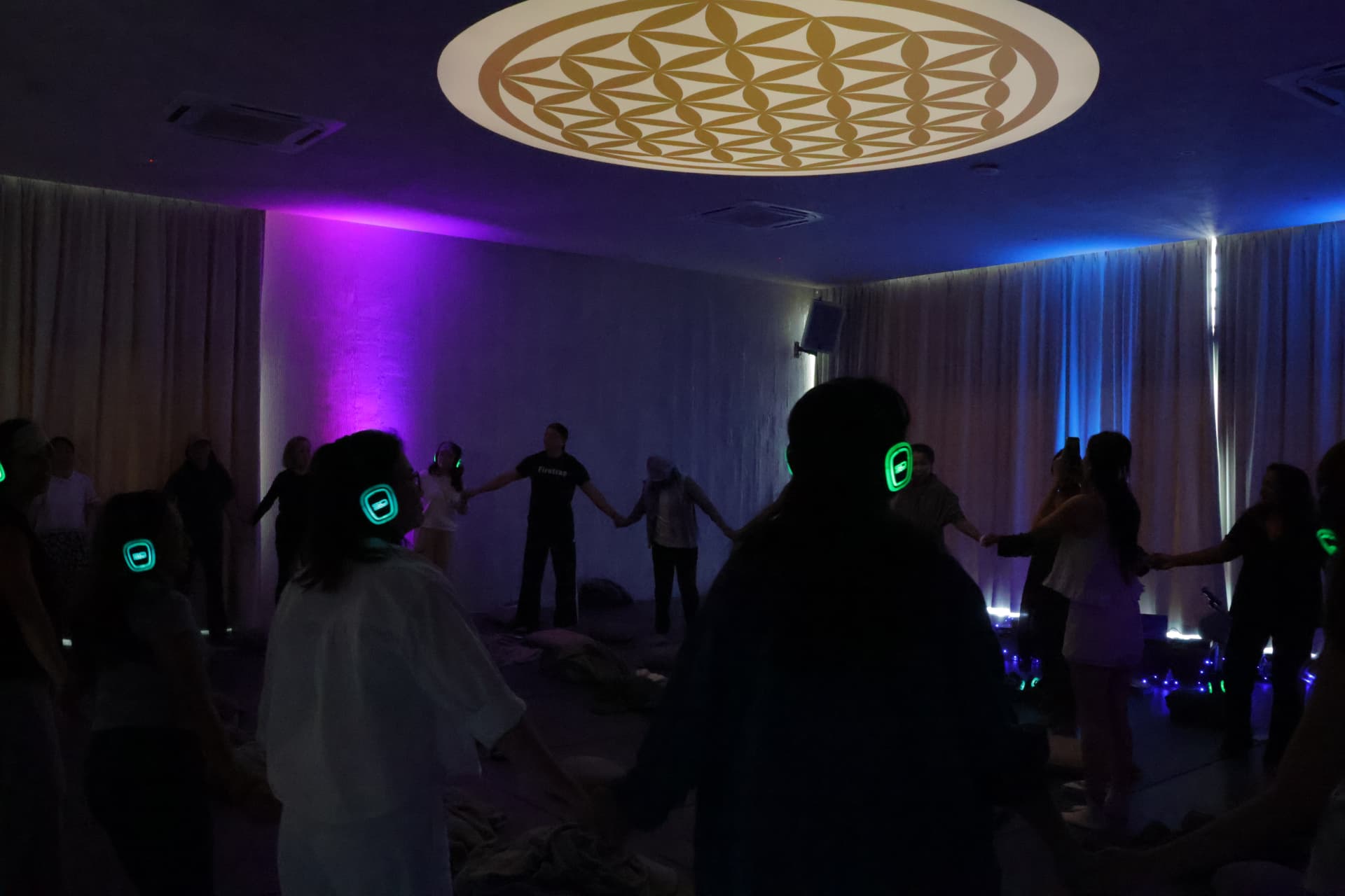 Guests standing in a circle in the softly lit club room